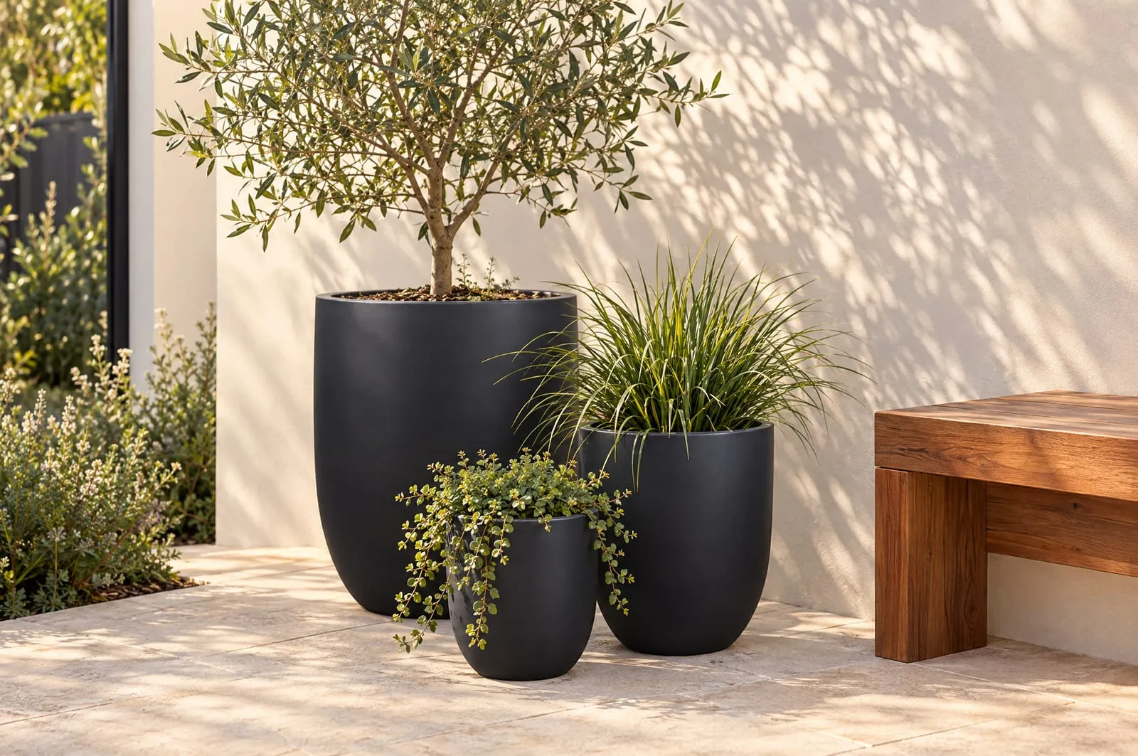 Havana pots in Charcoal grouped in the corner of a limestone courtyard