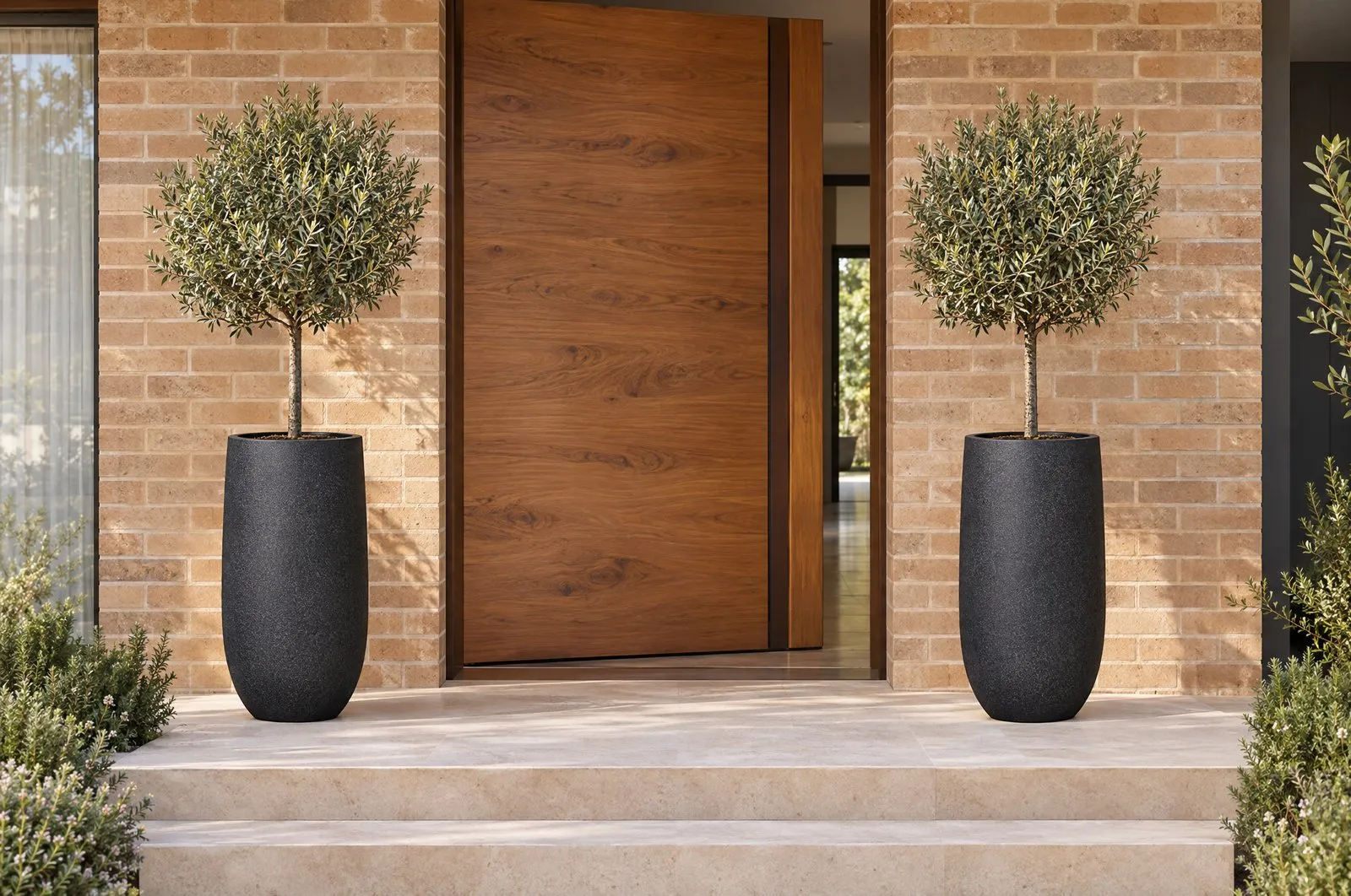 A pair of tall Sorento pots in Onyx either side of a timber front door