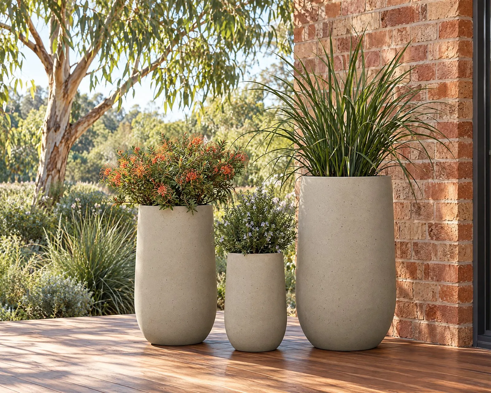 Sorento pots in Sand on a deck by a red brick wall